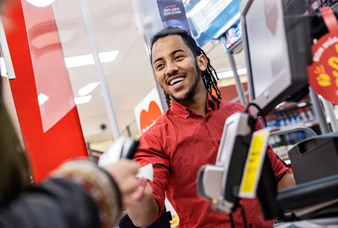 Employee in Willys store smiling 