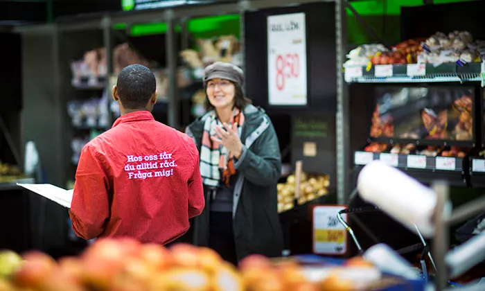 Employee and customer in store